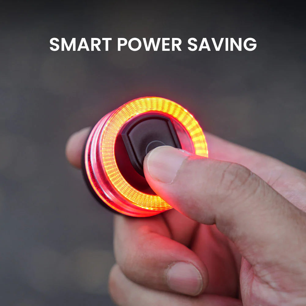 Hand holding the Vivi 50 light showing its illuminated ring during smart power saving mode
