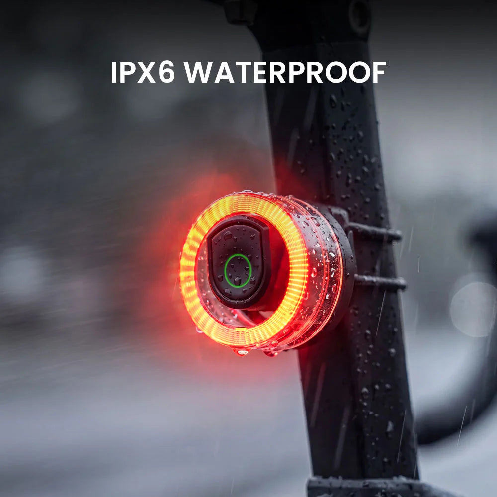 Vivi 50 light glowing on a bike seatpost in the rain, demonstrating IPX6 waterproof rating